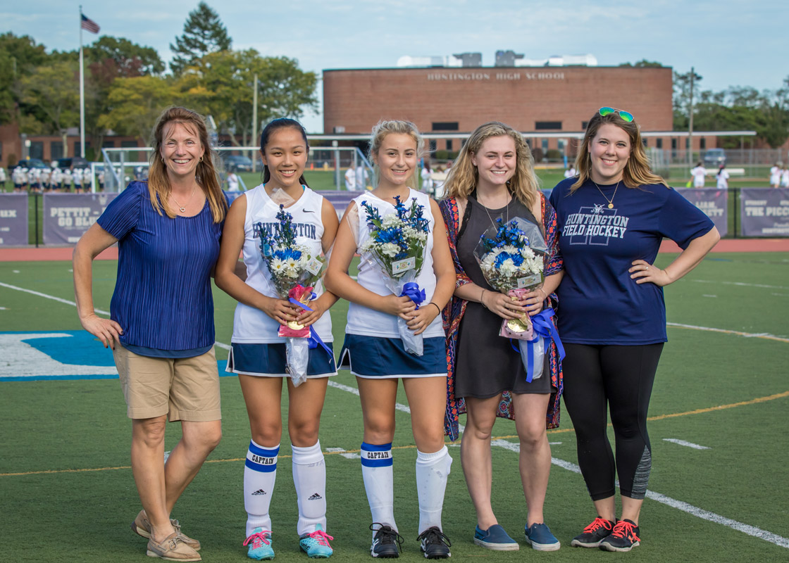 Lindsay McKenna (center) with fellow seniors and Blue Devil coaches on Senior Day last fall. (Mike Connell photo.)