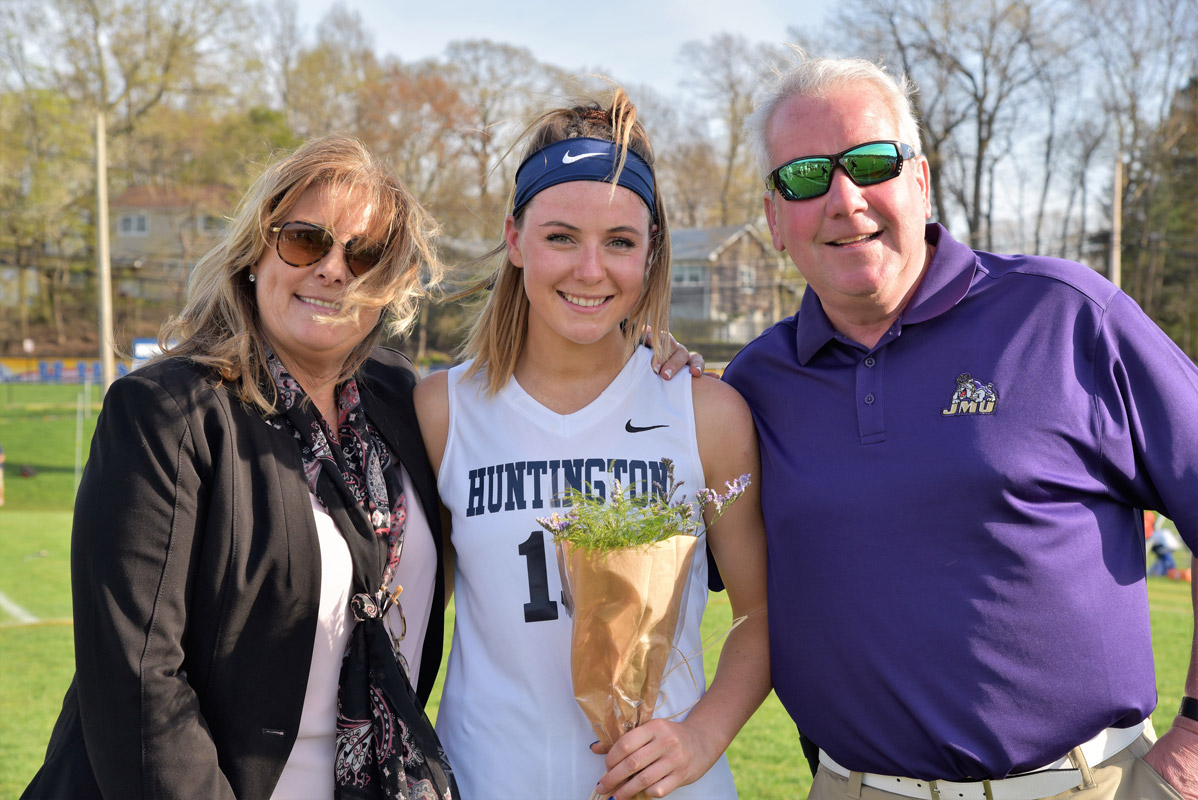 Emma Greenhill with her parents, Gina and Tom on Senior Day at Blue Devil Field.