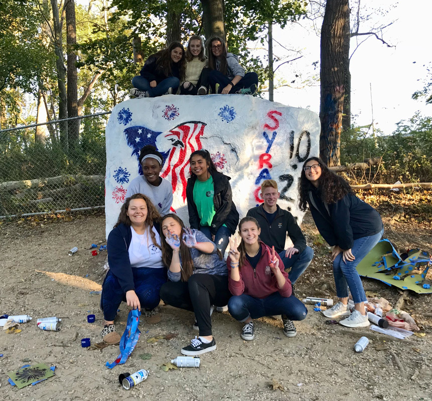 Sarah Glascock (top left) with fellow marching band members after painting The Rock.