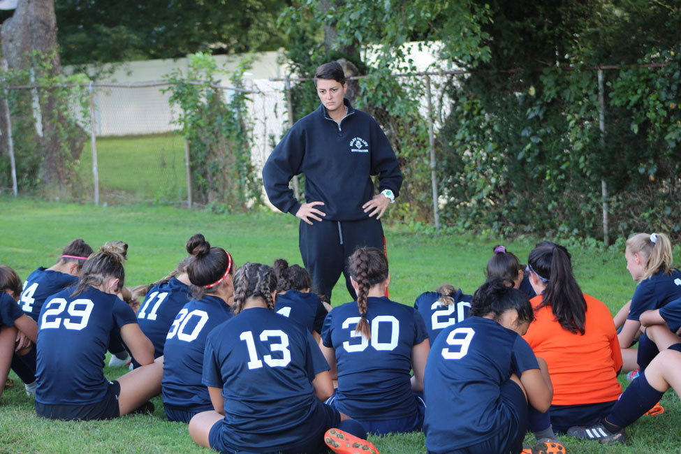 Huntington JV girls' soccer head coach Maria Canino talks strategy with her team at halftime. (Andy Ulloa photo.)