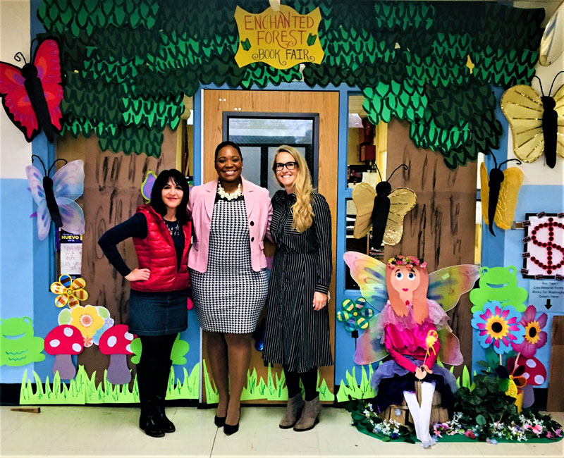 Washington Principal Dr. Michelle Richards is flanked by art teacher Maria Mazzola and PTA volunteer Molly England in the midst of the enchanted forest.
