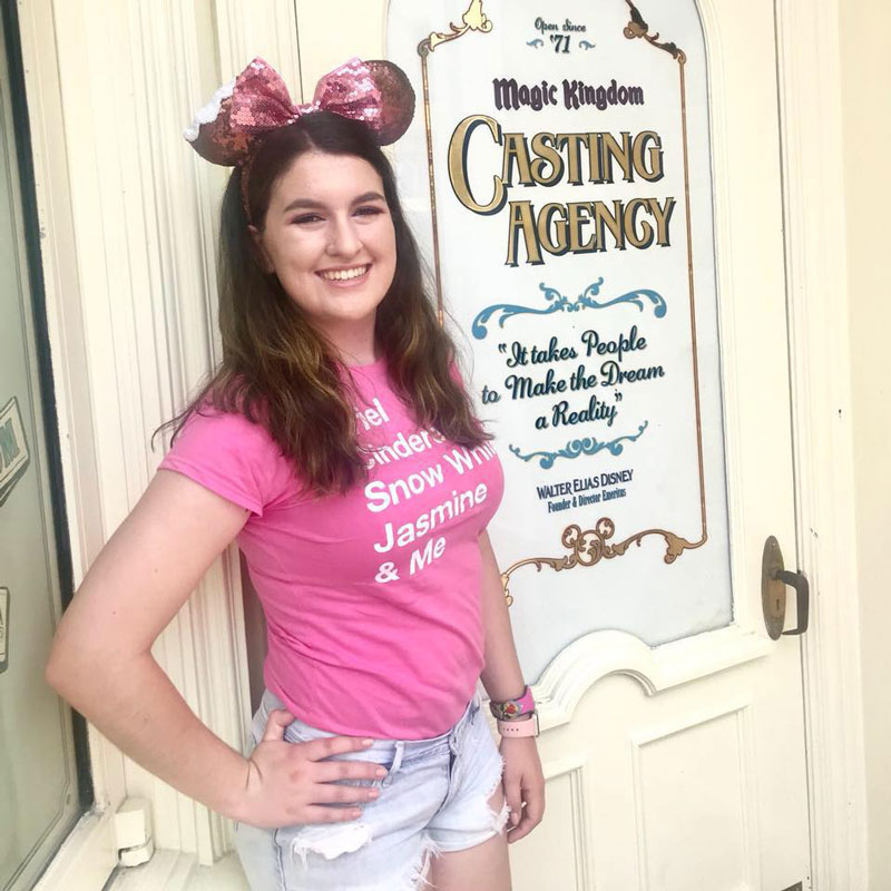 Huntington alum Mary Pulizzotto by the casting door at Walt Disney's Magic Kingdom.
