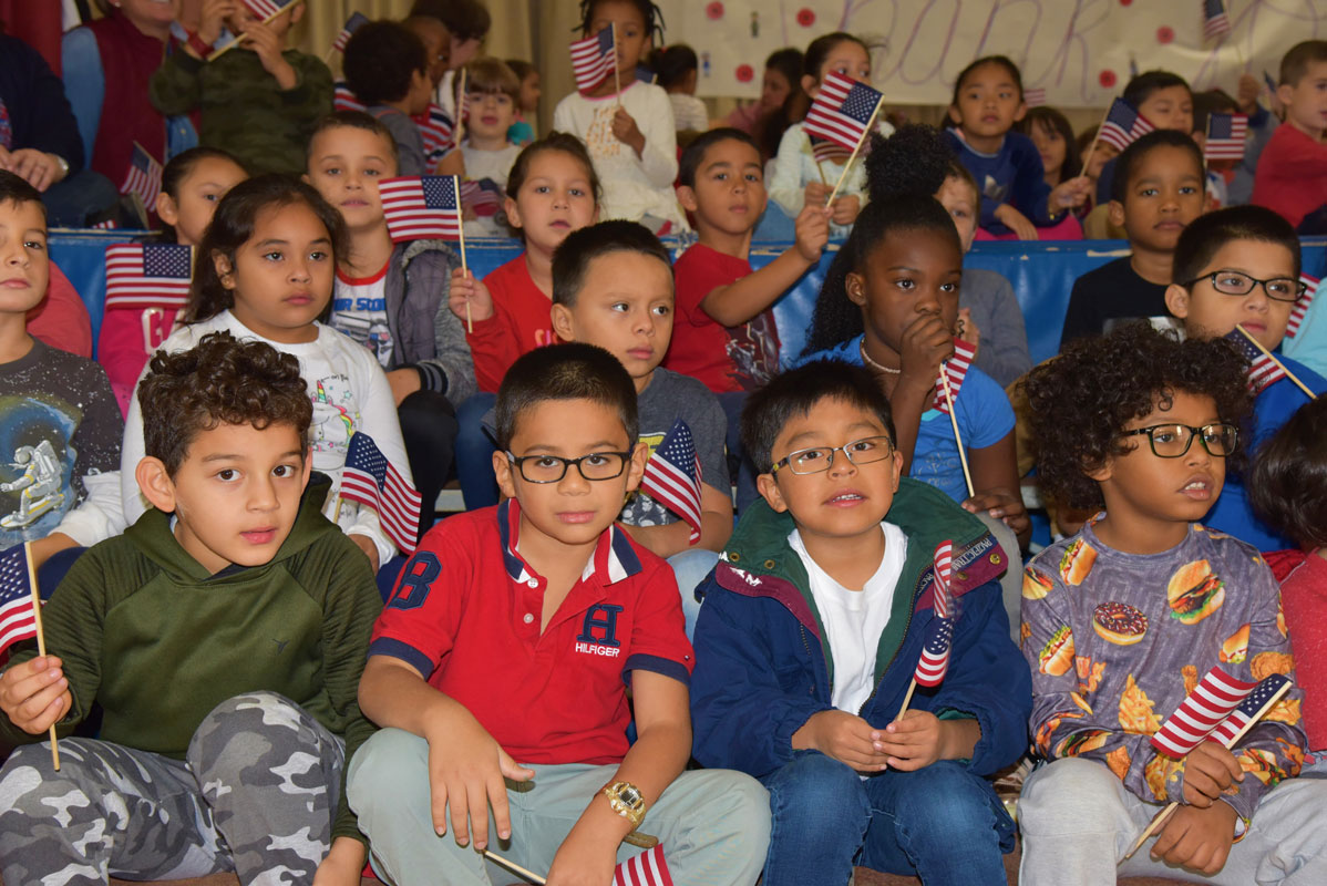  Students sat on or near the stage and recited poems and sang patriotic songs for the crowd. 