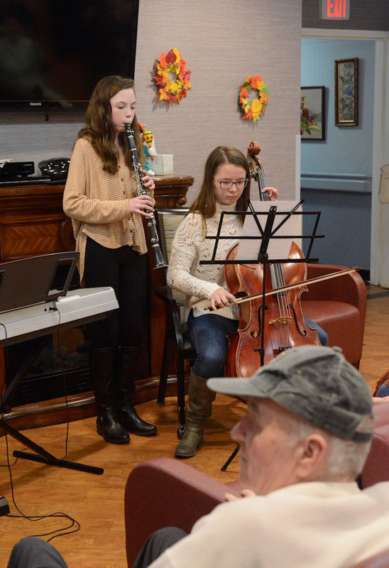 Cecilia Kye playing flute, Madelyn Kye playing cello.