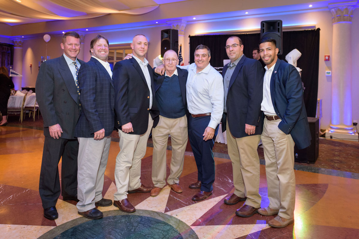 National Hall of Fame wrestling coach Lou Giani (center) is flanked by his former wrestlers. (Darin Reed photo.)