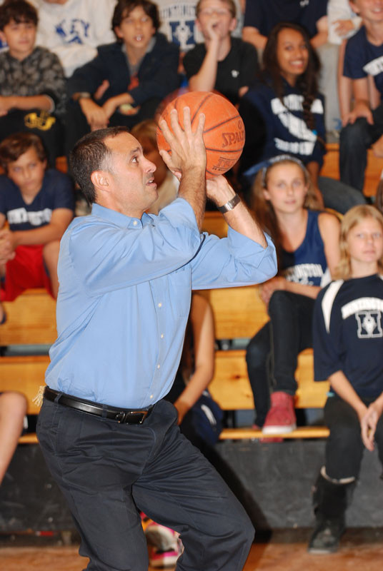 Principal John Amato at the line in a pep rally foul shooting contest.