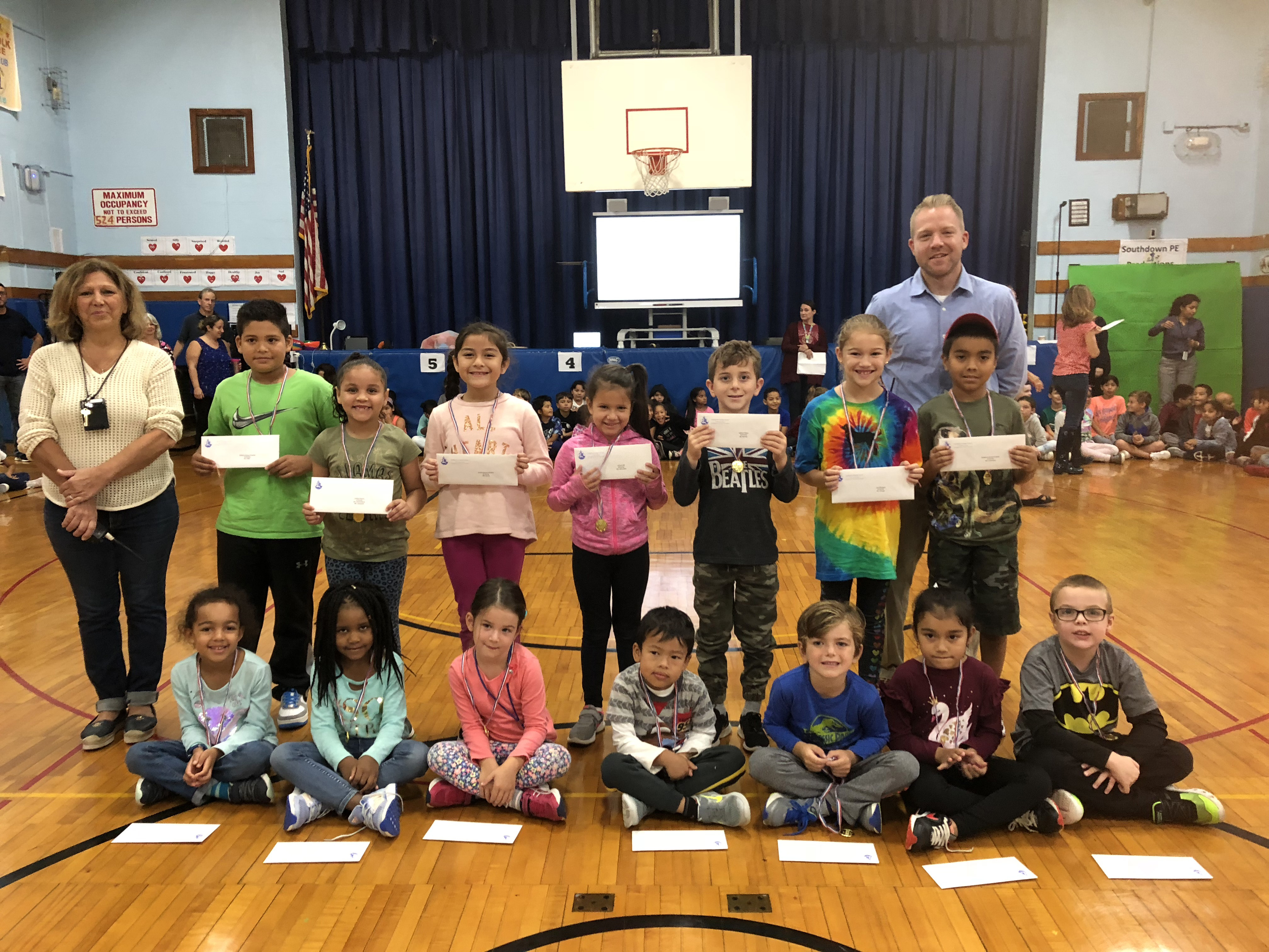 Principal Scott Oshrin and teacher aide Vincenza Roseto with Southdown Splash Award recipients