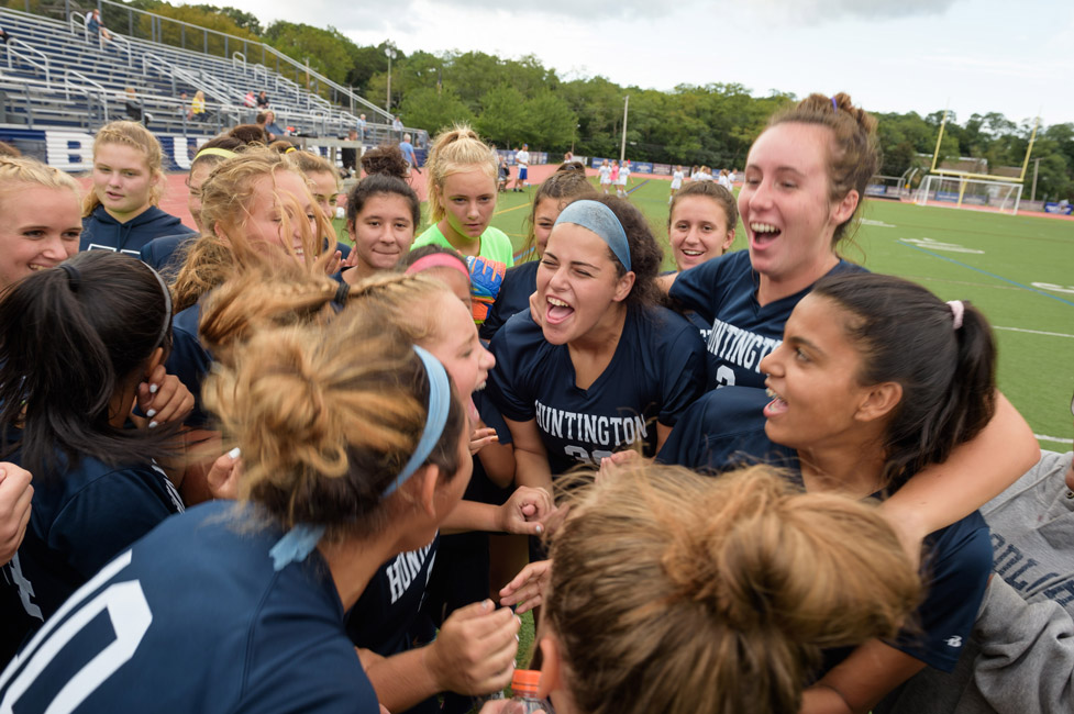 Riva Bergman (center) gets the Huntington girls' soccer team ready for the game. (Darin Reed photo.)