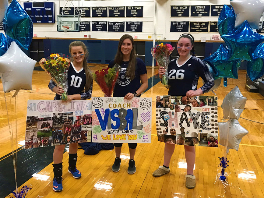 Huntington girls' volleyball head coach Lauren Visbal is flanked by Caroline Lenze and Shaye O'Beirne on Senior Day.