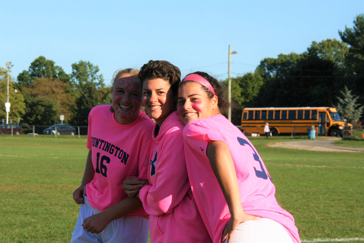 Riva Bergman (right) and close friend Alex Gerbavsits flank soccer coach Maria Canino.