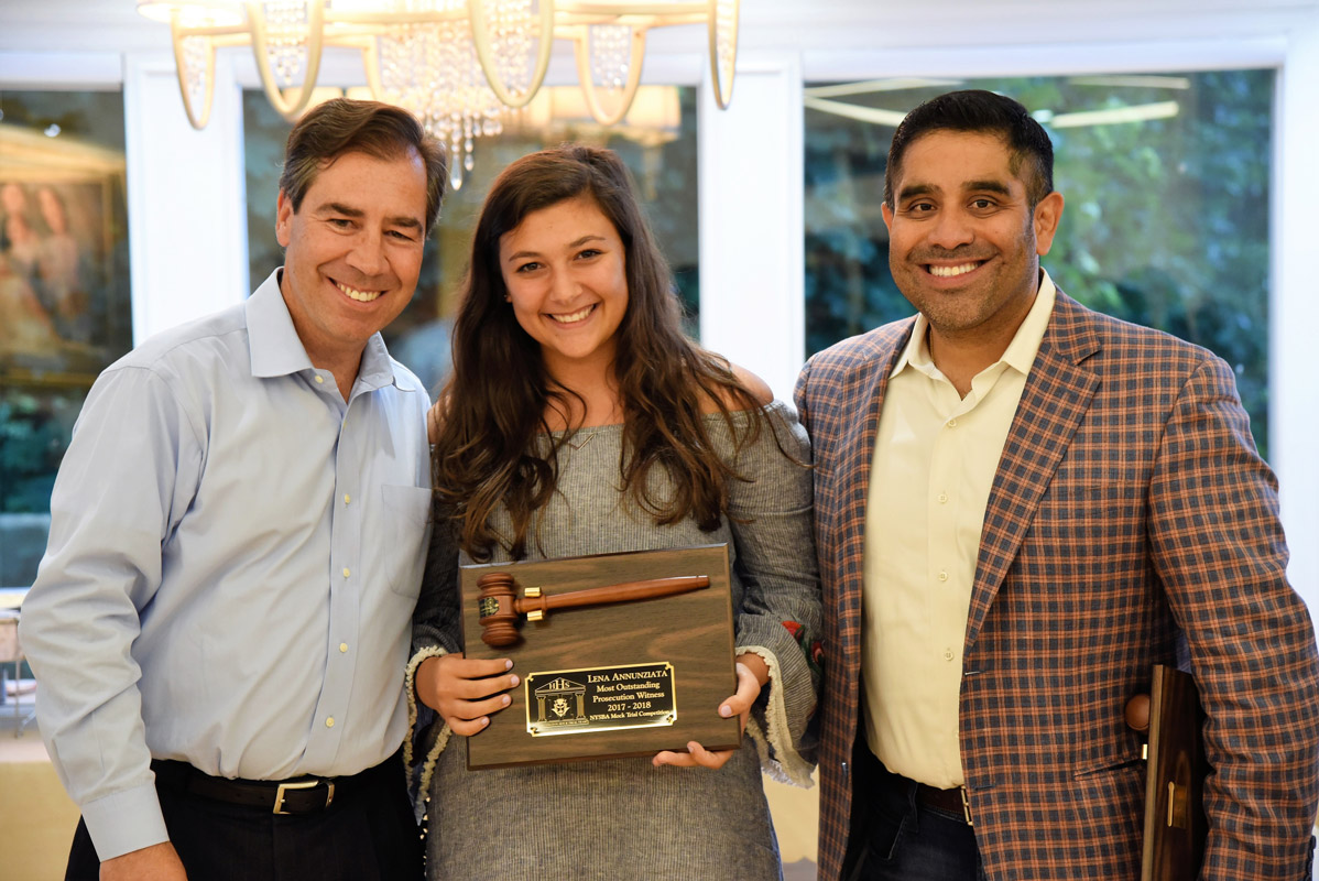 Mock Trial team Most Outstanding Prosecuting Witness Award recipient Lena Annunziata with legal advisors John LoTurco and Xavier Palacios.