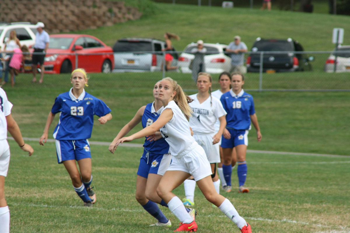 Alex Gerbavsits (in white) keeps her eye on the ball.