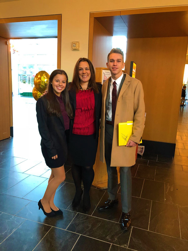 Yady Acevedo and John Panos flank teacher Paige Furman at LIU Post.