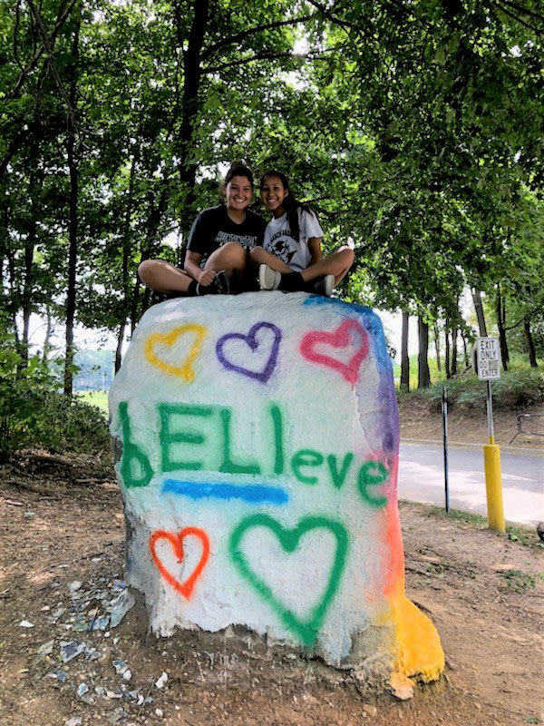 Jenna Yabroudy and Natalie Gonzalez atop The Rock dedicated to Eli Mollineaux.