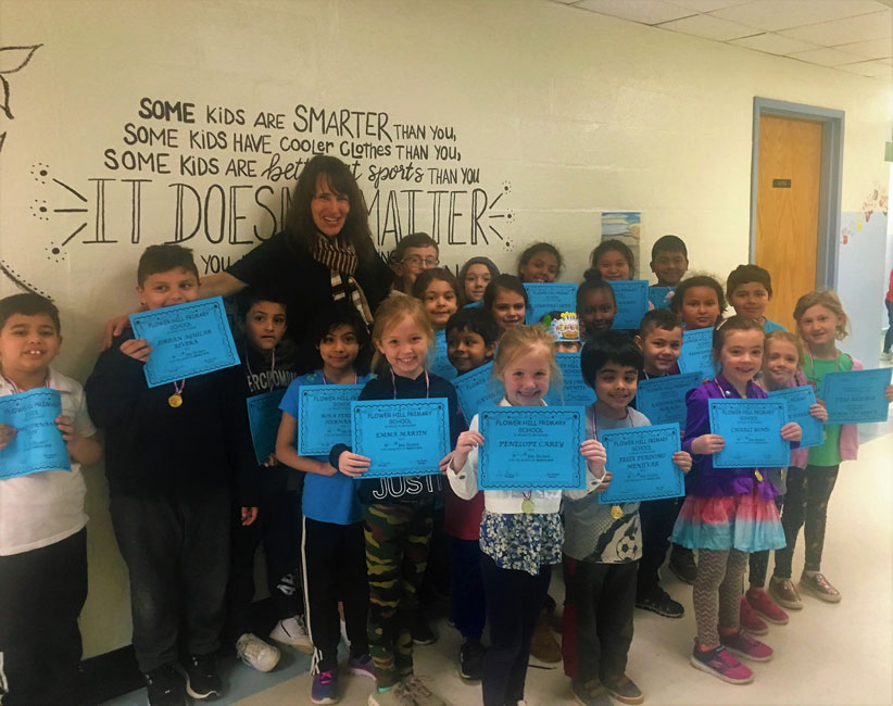 Flower Hill School Principal Lucia Laguarda with the student award recipients.