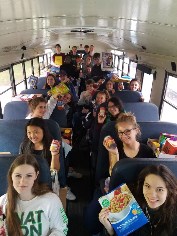 Huntington student government members delivered two busloads of food to the hungry.