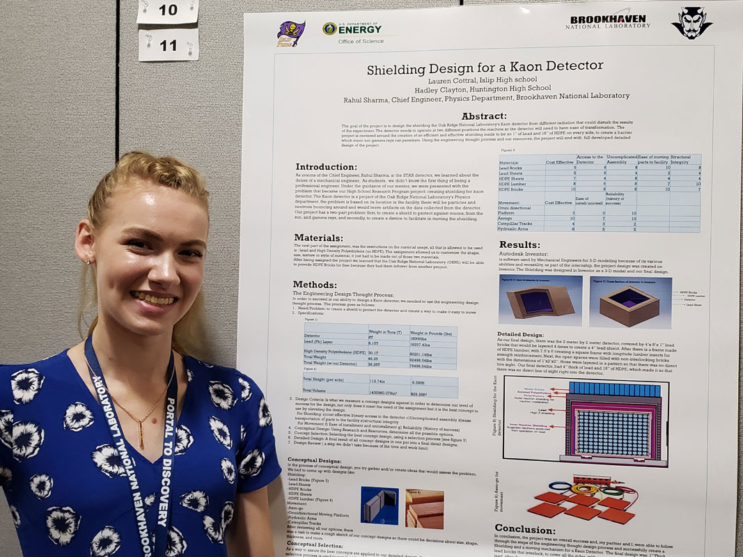 Hadley Clayton at Brookhaven National Lab with a poster board summarizing her summer project.