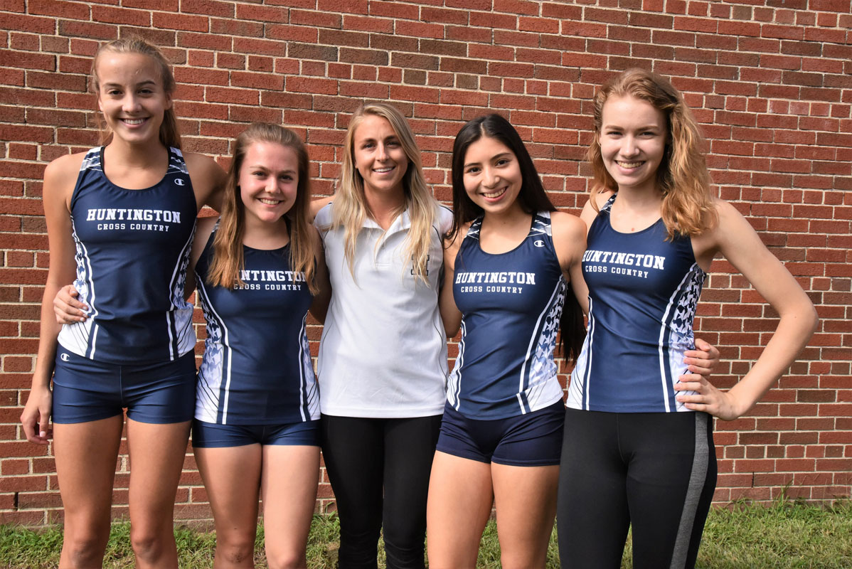 Huntington cross country captains Colette Baron, Valerie Rogel, Keily Rivas and Hadley Clayton flank Coach Beth Vogelsang (2)