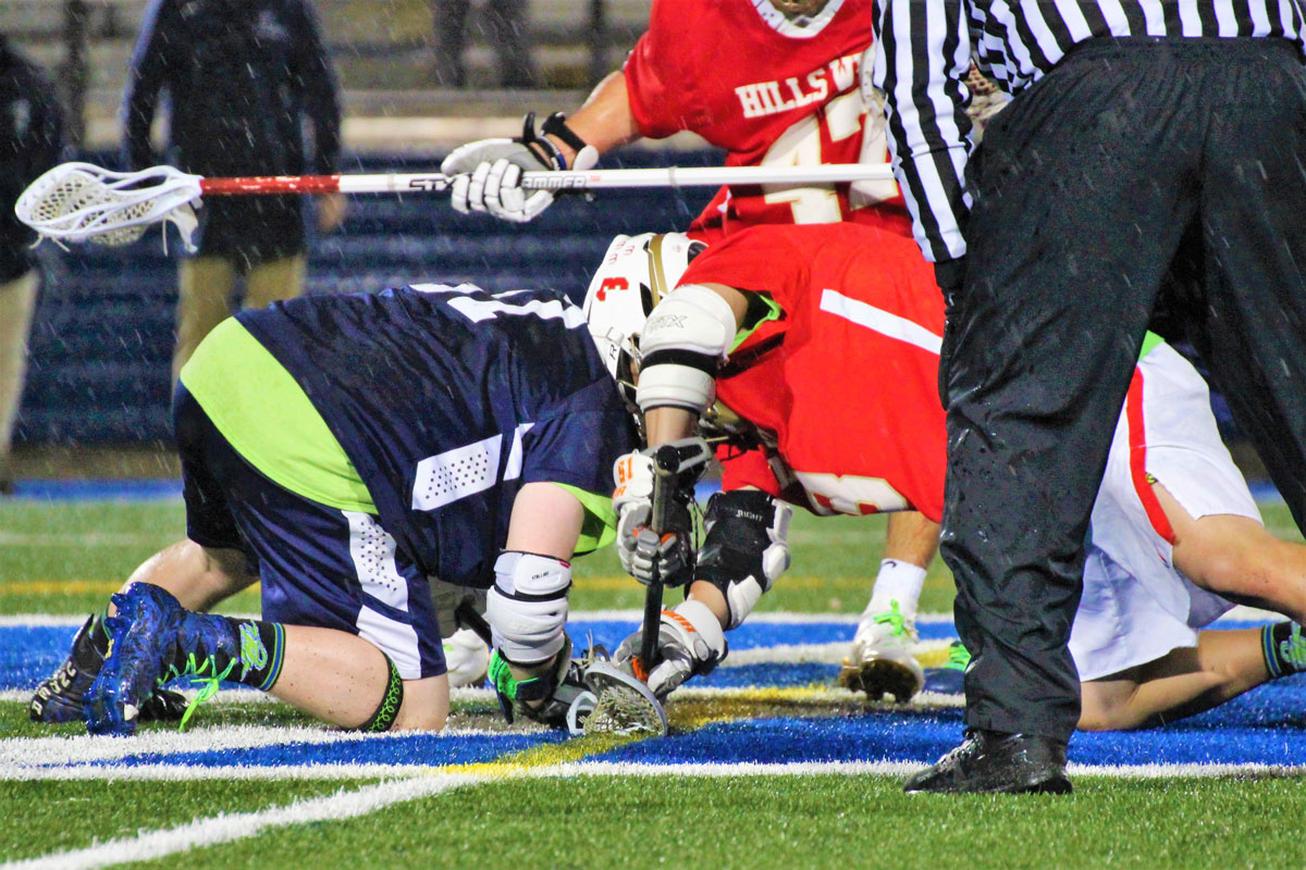 Winning faceoffs was crucial to Huntington nipping Hills West last Friday. (Erik Krisch photo.)