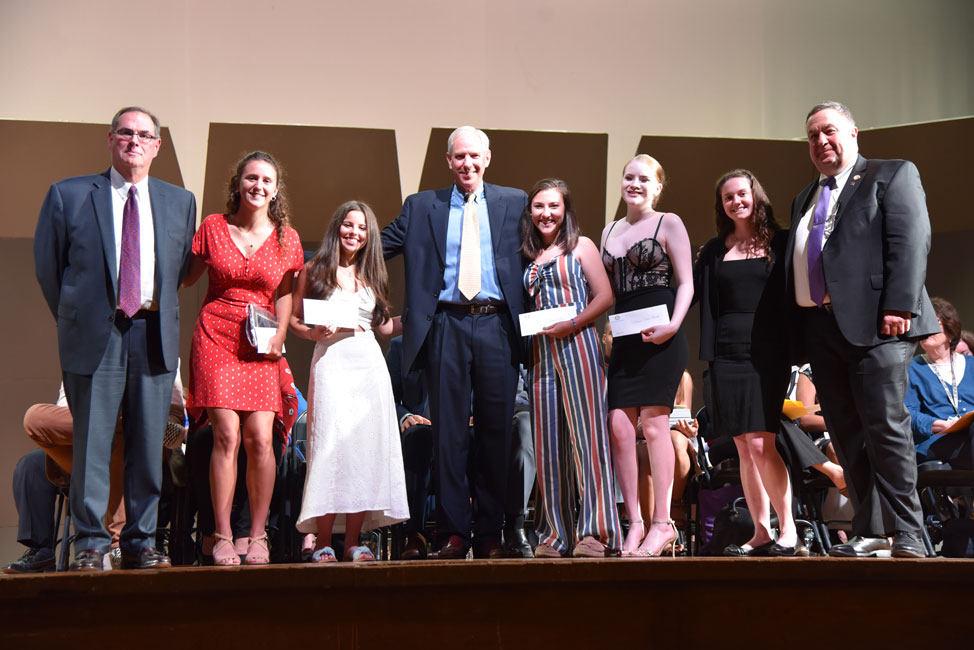 Rotary Club officials with the five Huntington seniors who won $16,000 in scholarship monies 