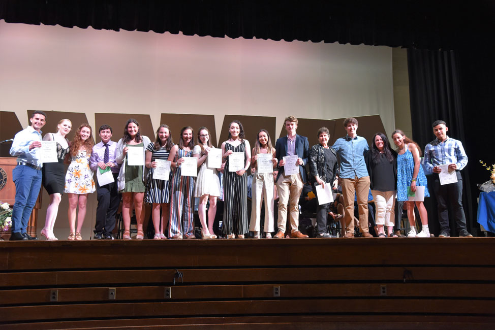 bELIeve Project - Eli Mollineaux Memorial Scholarship Award recipients on the Huntington High School stage 