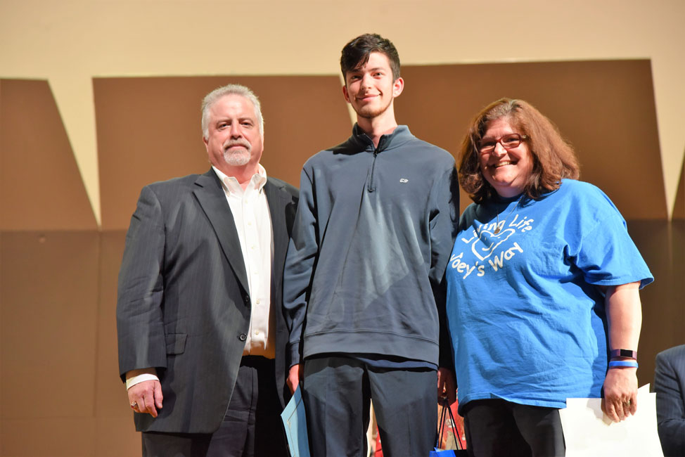 Huntington Class of 2019 member Daniel Thompson with Glen and Anne Manaker at the award ceremony 