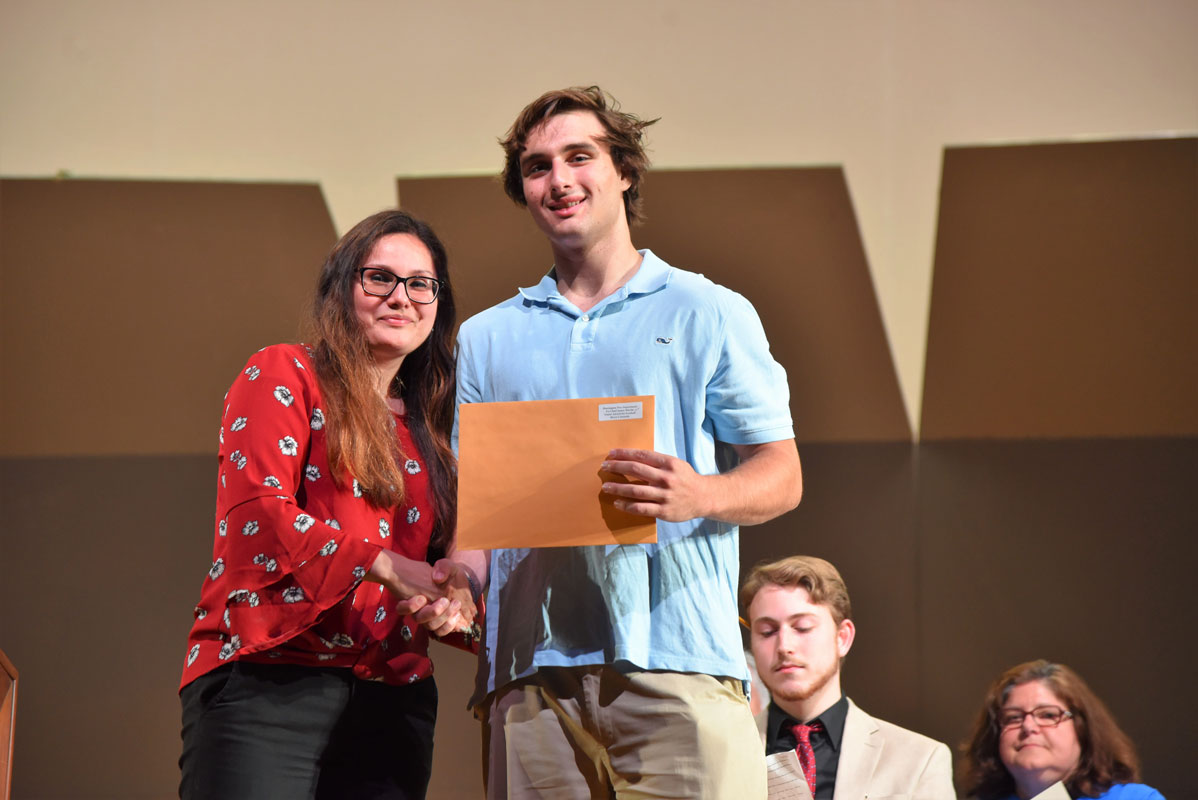 Guidance counselor Diana Bonilla presented Bryce Criscuola with the Ex-Chief Jimmy Martin Award for Football 