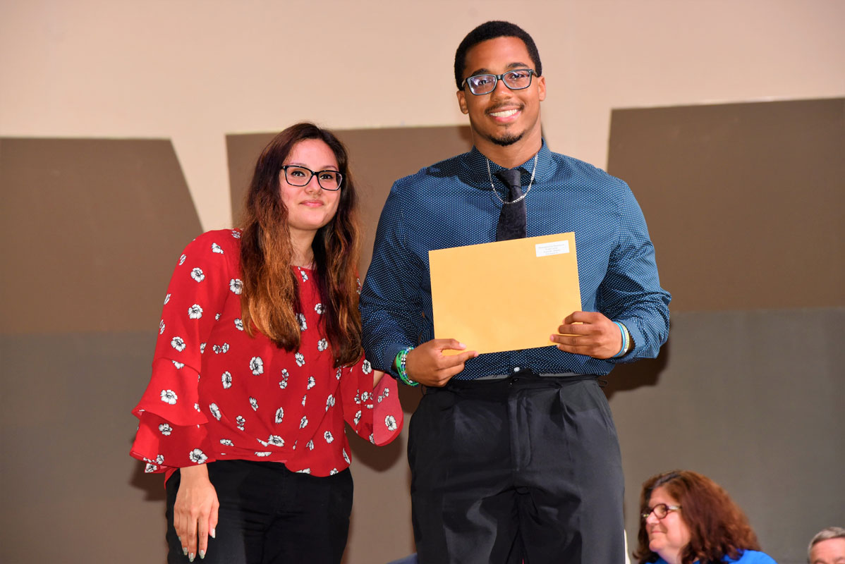 Eric Sands (pictured with school counselor Diana Bonilla) won the Huntington Fire Dept's Frank Carino Award for Athletics.
