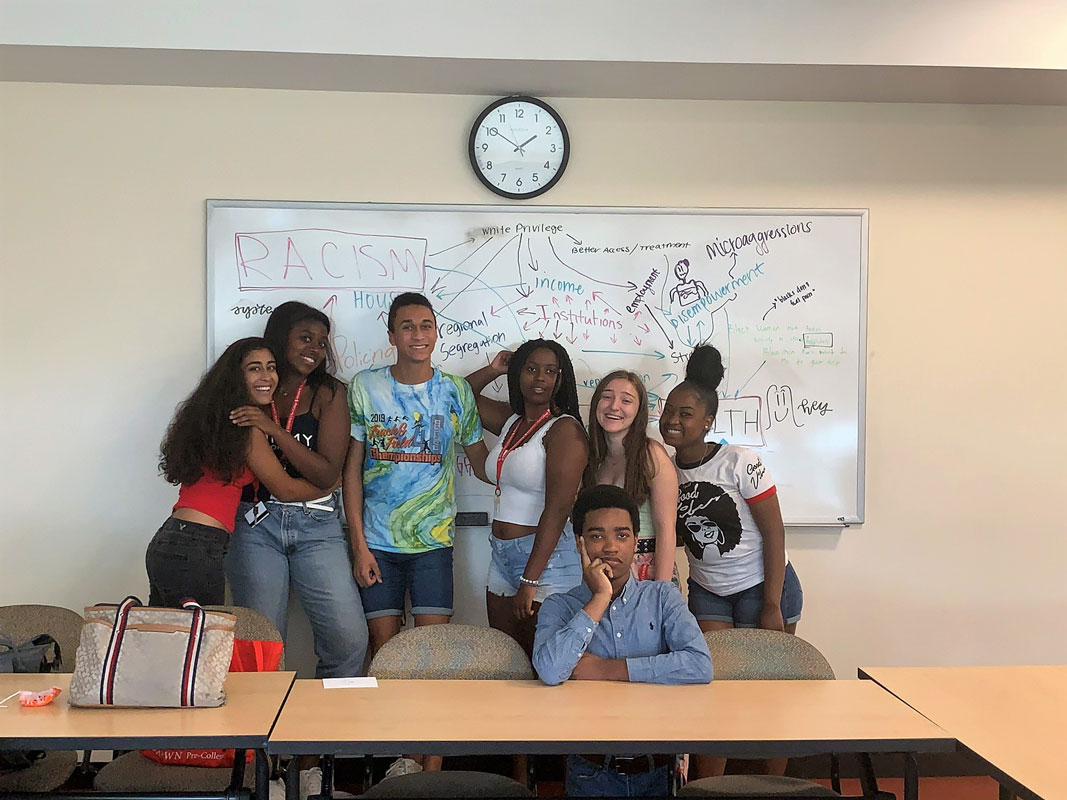Robert Jean-Gilles (seated center) with classmates having fun at Brown University this summer.
