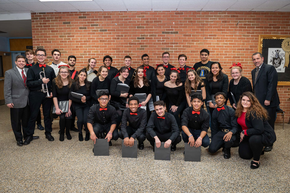 Supt. Jim Polansky and choir director Victoria Garbarino with the vocalists and instrumentalists.