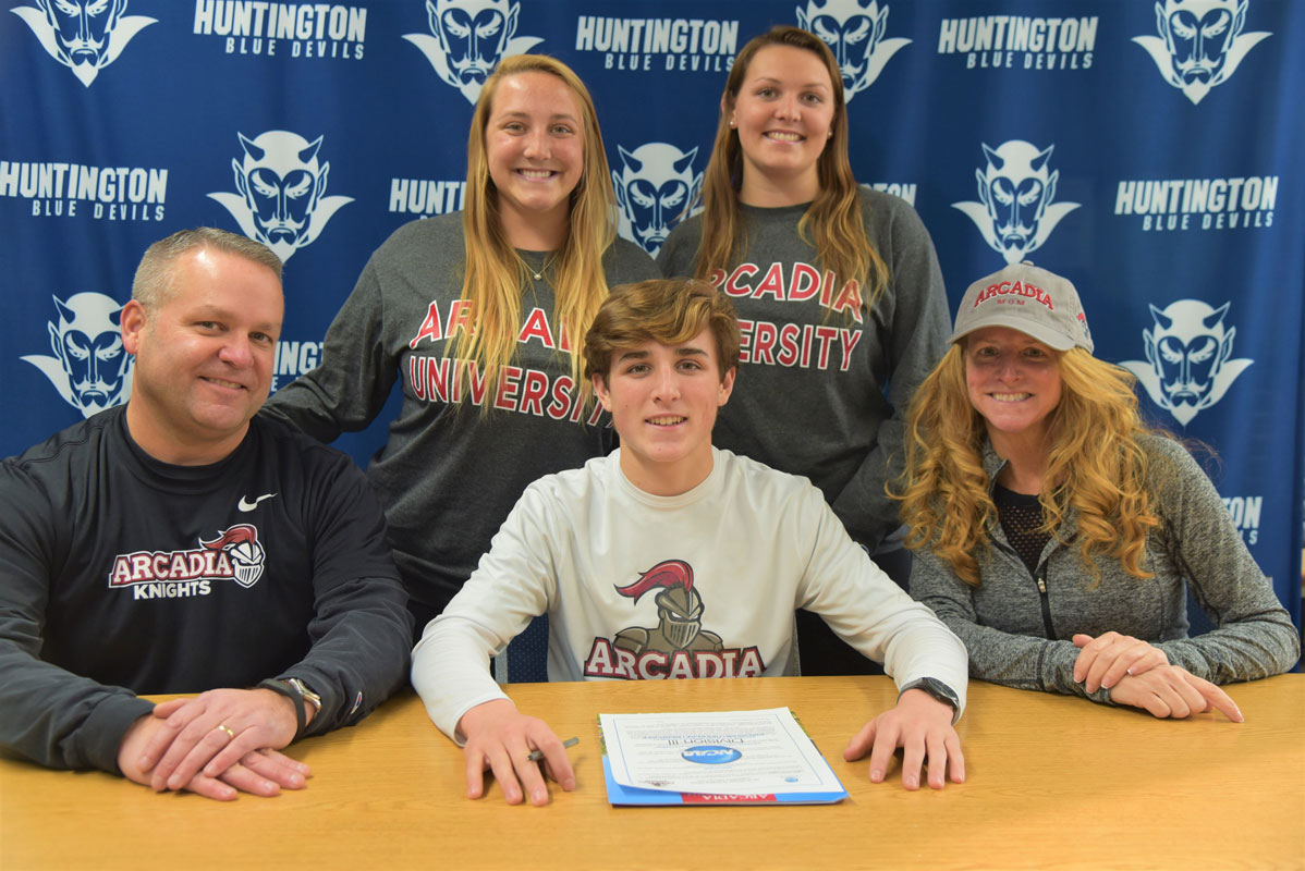 Huntington senior Billy Burton commits to Arcadia University while surrounded by his parents and sisters (1)
