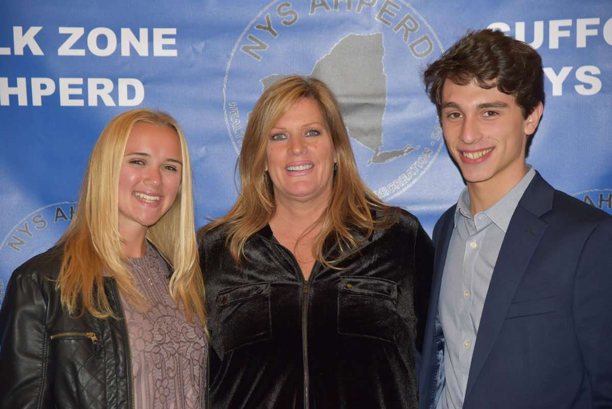 Huntington Director of Athletics Georgia McCarthy with Suffolk Zone Award recipients Alexandra Gerbavsits and Julien Rentsch.