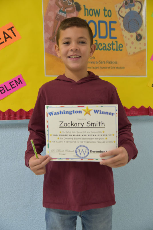Washington School third grader Zackary Smith sure is a proud award recipient.