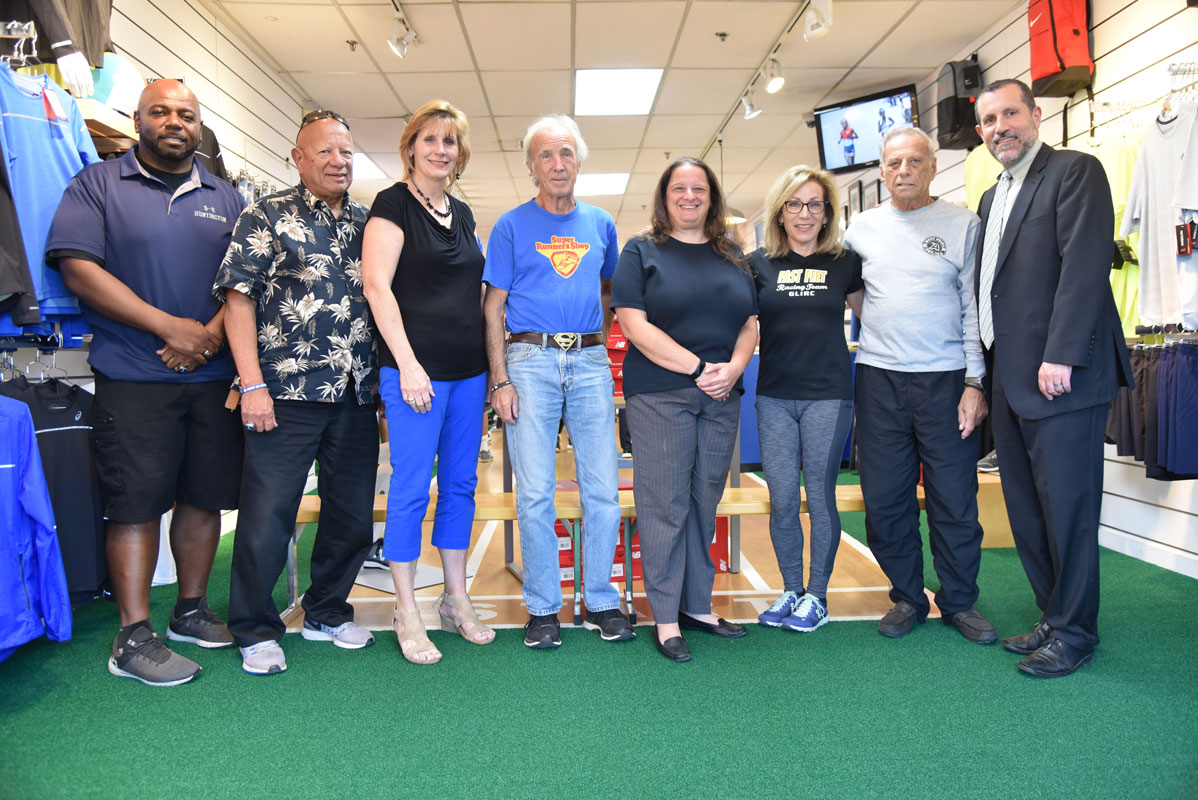 Huntington Supt. Jim Polansky (right), track coaches and GLIRC officials at Super Runners Shop