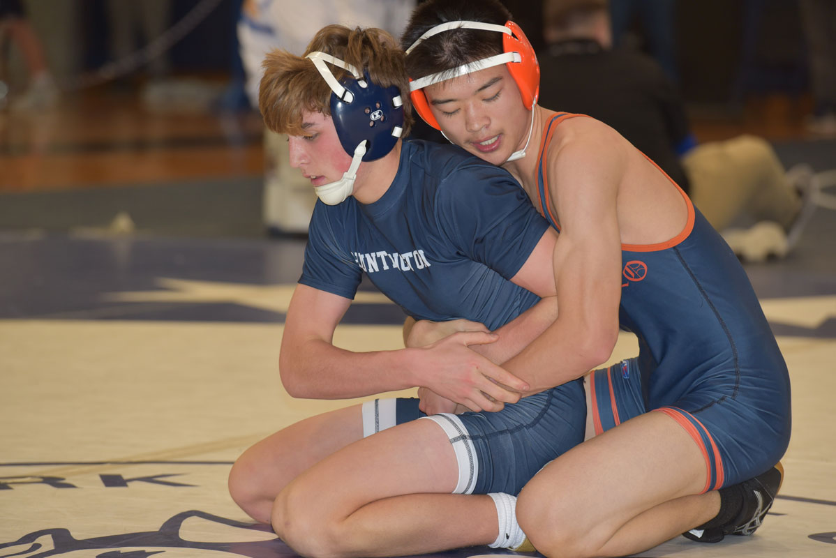 Huntington's Billy Burton (bottom) looks for hand control and he fights to escape last Saturday.