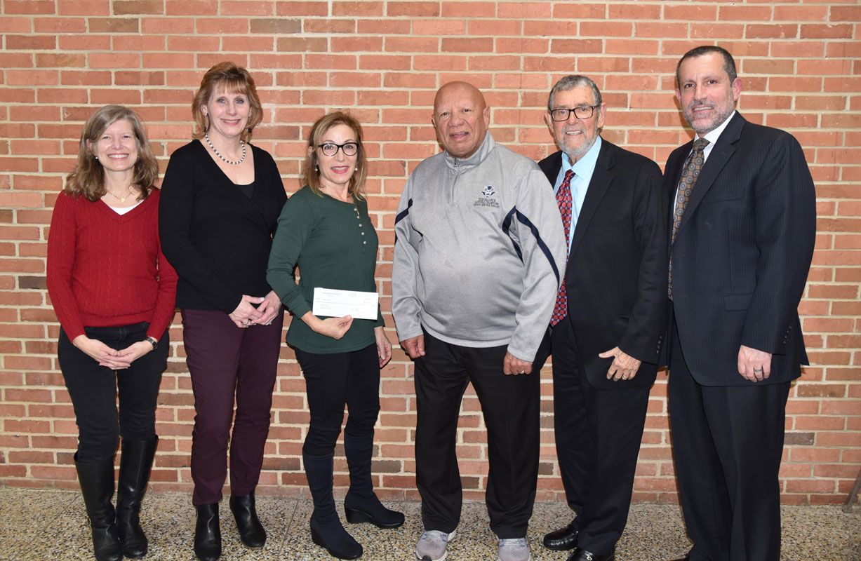 Treasurer Tracey Epstein presents a check to Coach Eli Acosta, BOE President Jennifer Hebert and Supt. Jim Polansky 