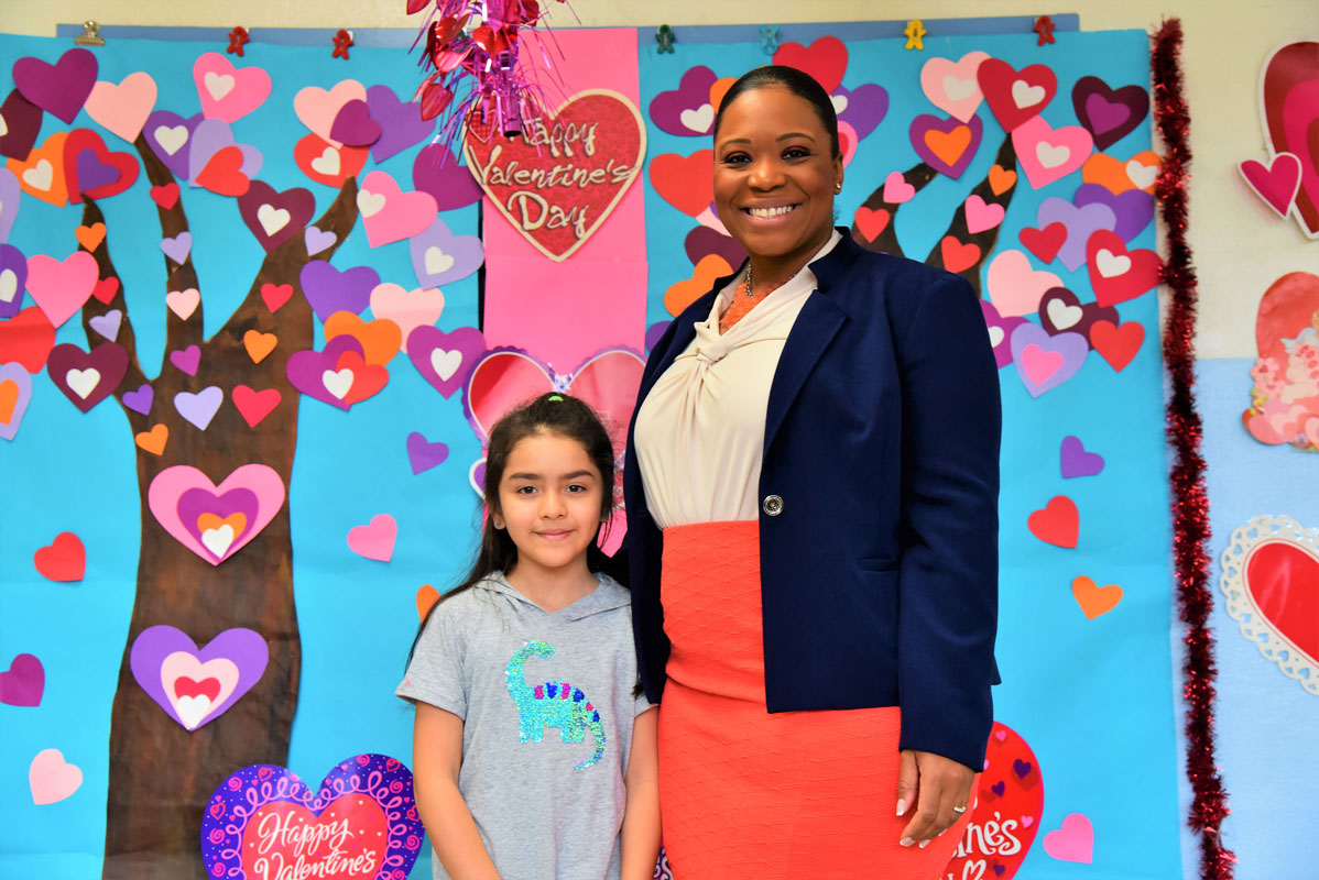 Second grader Isabella Ulloa with Washington School Principal Michelle Richards