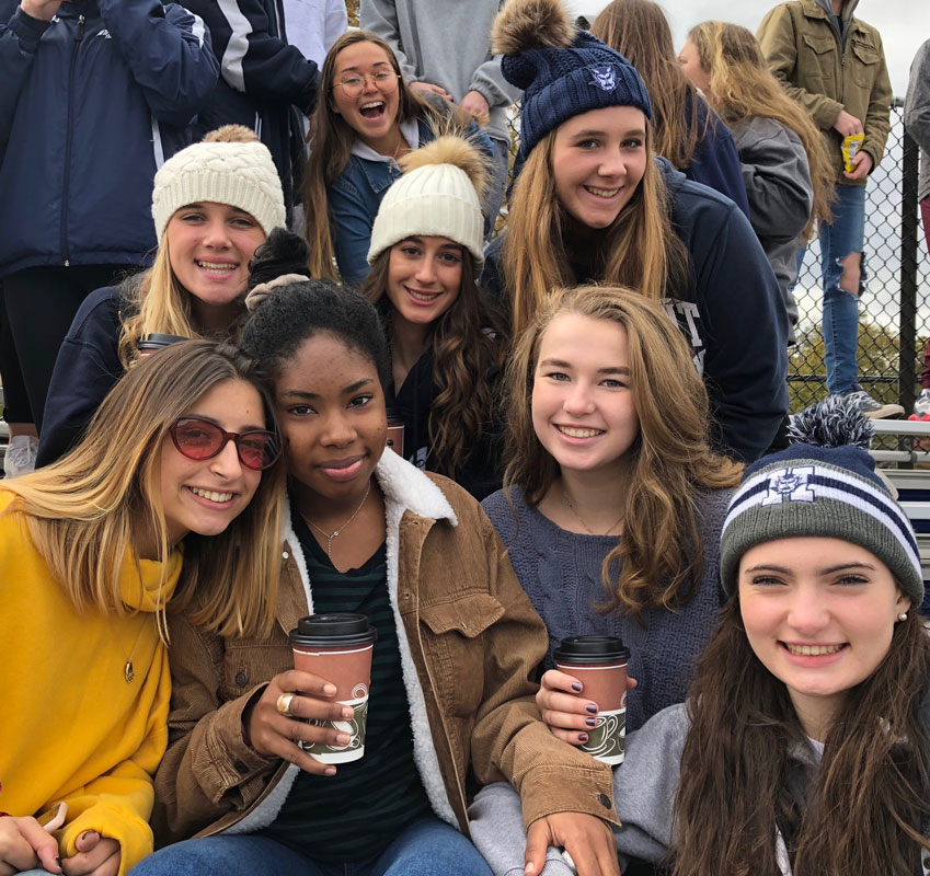 Madison Lange (top right) with her classmates at a Huntington football game.