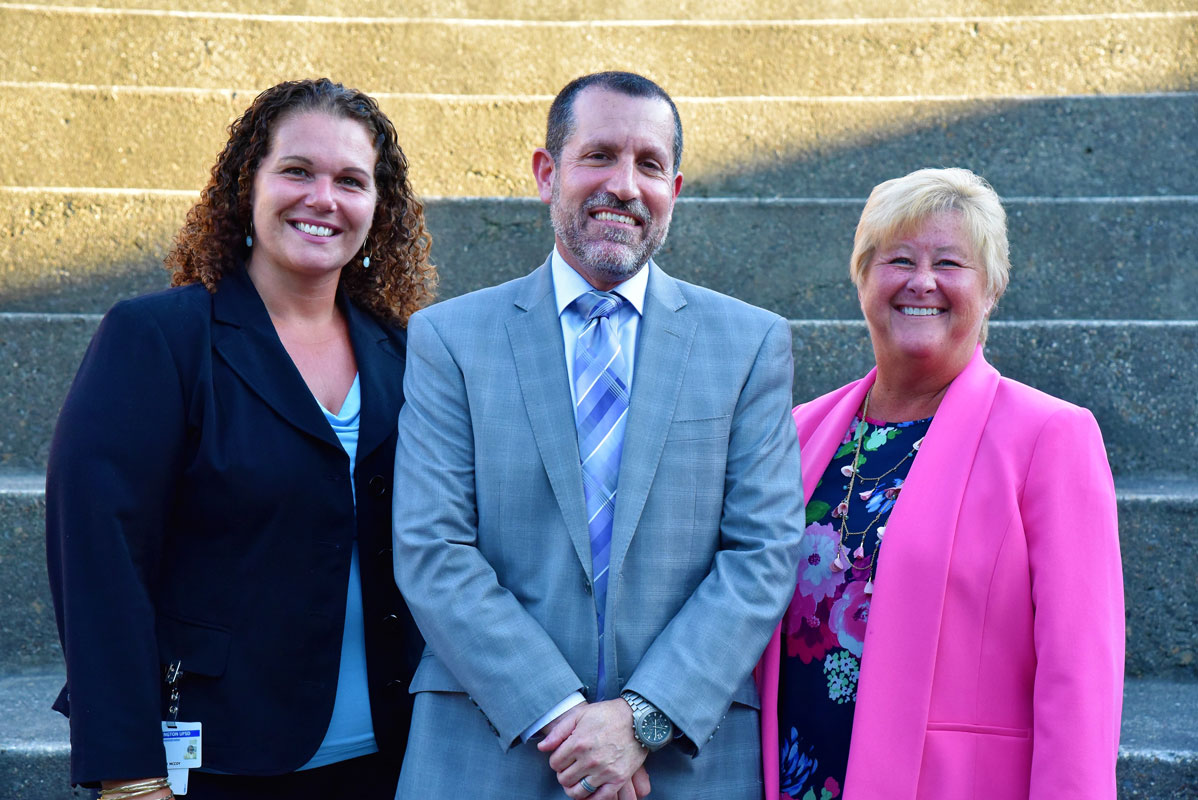 Huntington Superintendent James W. Polansky is flanked by Assistant Superintendents Beth McCoy and Kathleen Acker.