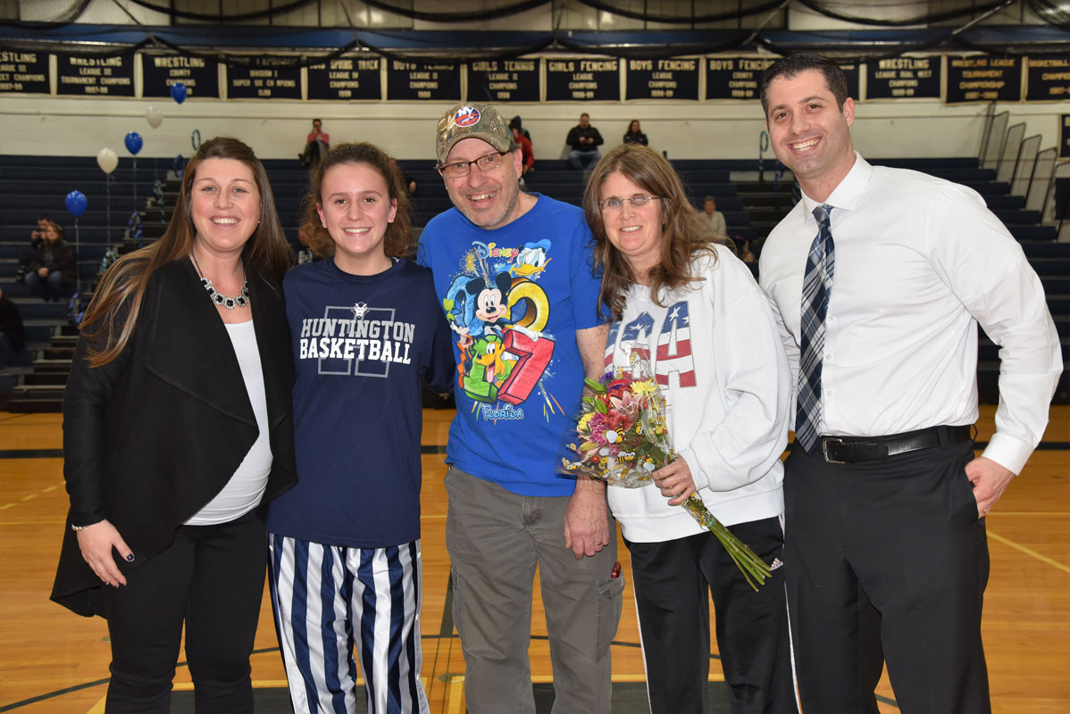 Alyssa Sorensen (second from right) with her parents and coaches on Huntington girls' basketball Senior Day 