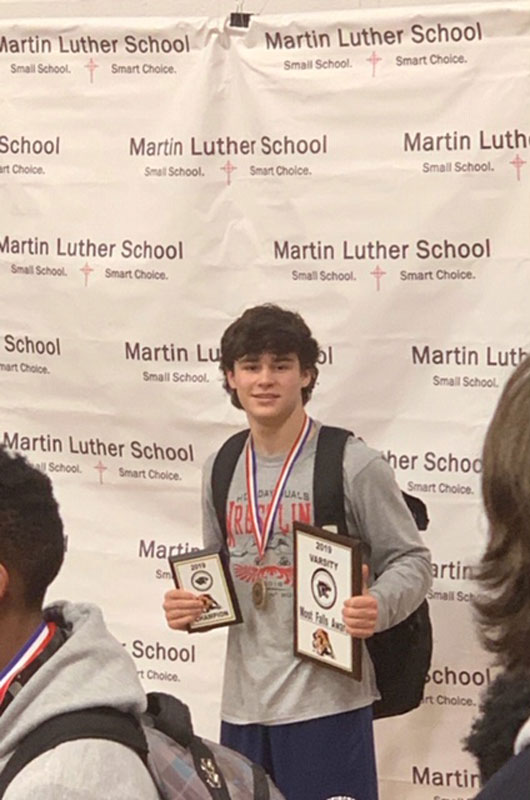 Huntington's Ryan Baker with his individual and team first place awards.