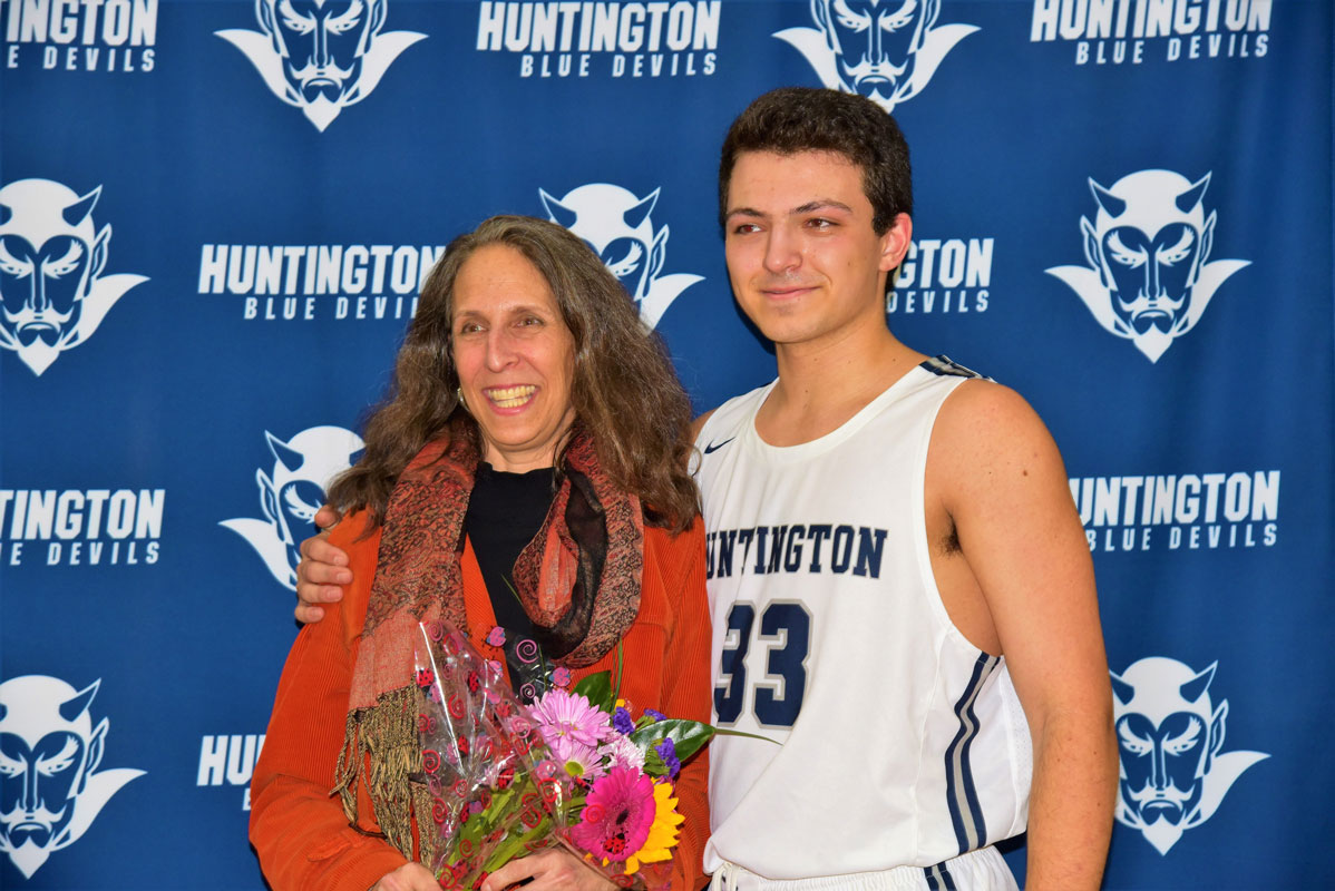 Jonah Anastos  with his mom, Rachel on Huntington boys' basketball Senior Day 