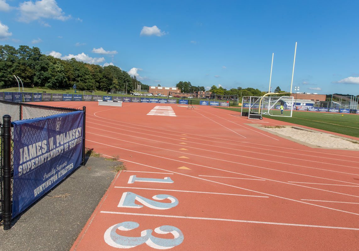 Field banners surround the Blue Devil Stadium track. (Mike Connell photo.)