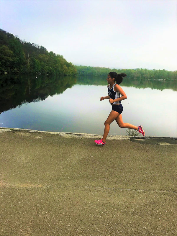 Blue Devil cross country runner Diya Rai-Gersappe runs past Bear Mountain's Hessian Lake.
