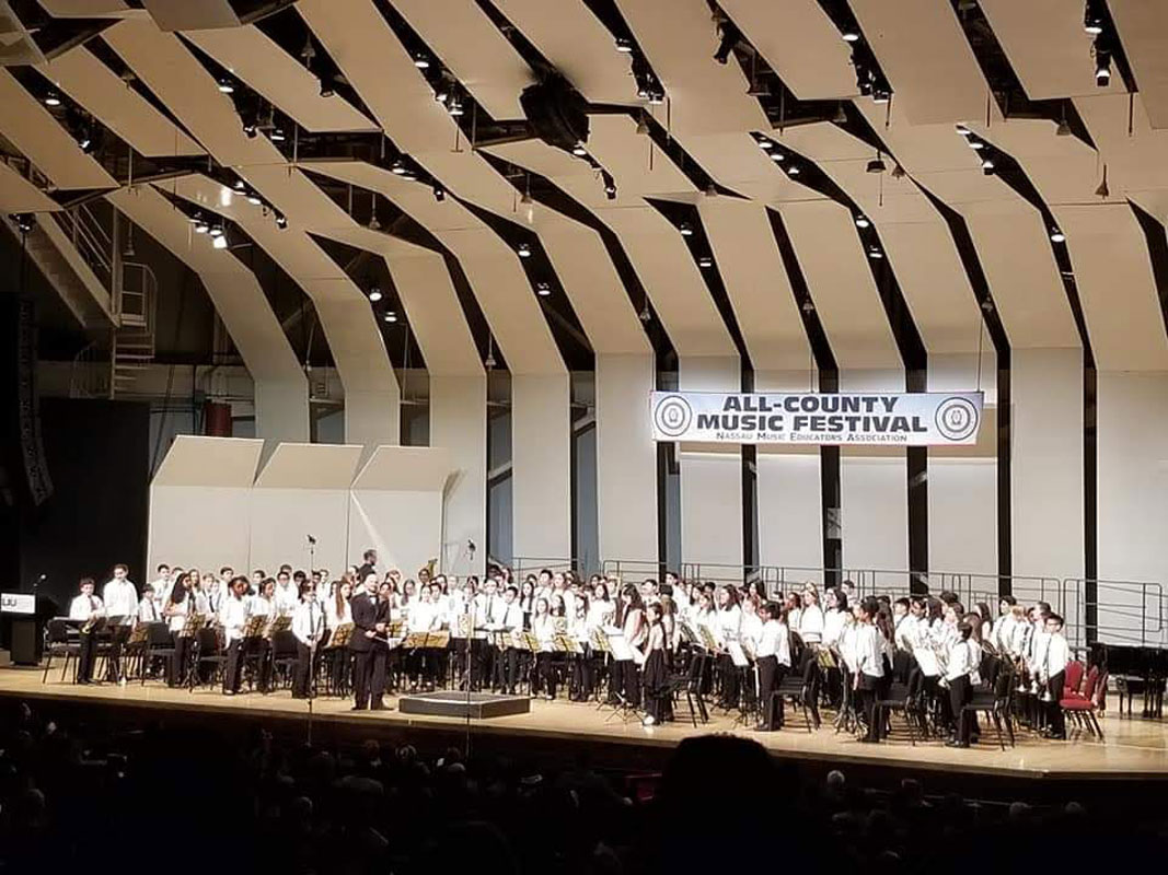 Finley music teacher Frank Battista directed the Nassau band at the Tilles Center.