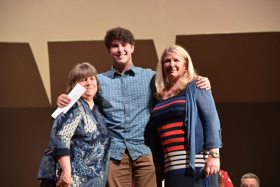 Class of 1968 members Barbara Schaefer Nienstedt and Marilyn Godde Aliperti flank scholarship recipient Sam Roberts 