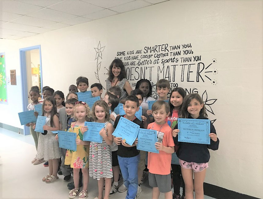 Flower Hill Principal Lucia Laguarda with June's Star Student Award recipients.
