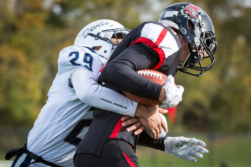 Hard-hitting defensive back Lex Colato (No. 29) makes the tackle. (Darin Reed photo.)