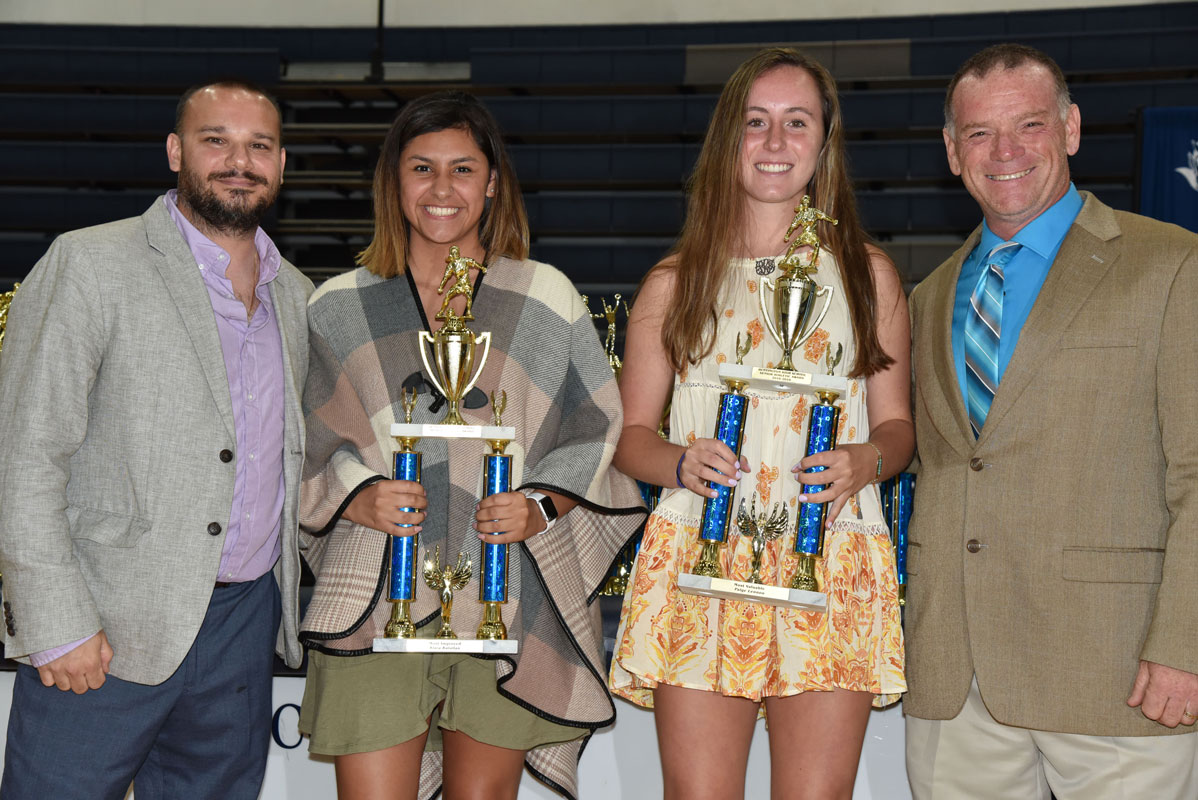Kiara Rafailan and Paige Lennon are flanked by Huntington girls' soccer coaches Vincent Tannazzo and John Walsh 