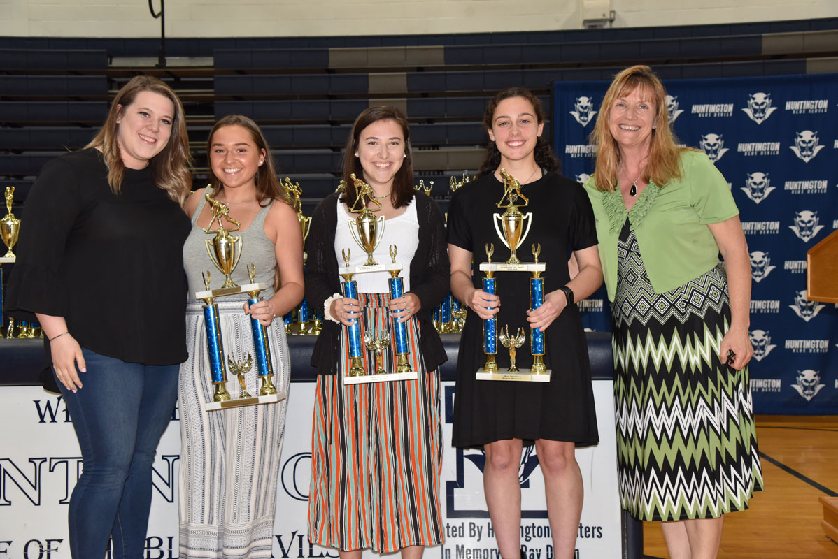 Huntington field hockey coaches Allison Conlon and Kathy Wright flank Brooke Goldsmith, Phoebe Walther and Morgan Minicozzi